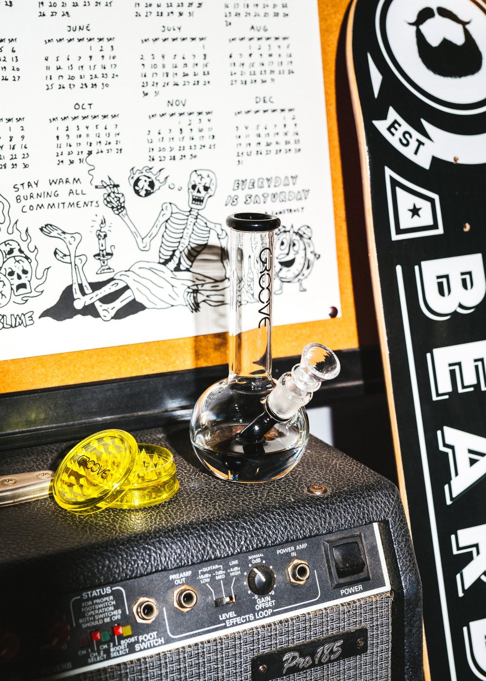 GROOVE glass and a yellow GROOVE grinder sitting on top of a guitar amp